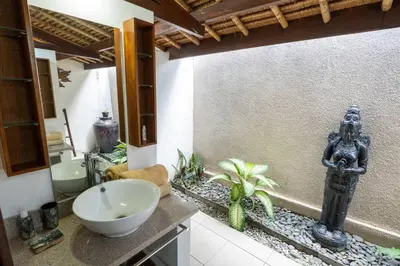 a bathroom with a sink and a statue in it at Kangin villa 2 bedrooms in the heart of Seminyak in Kuta