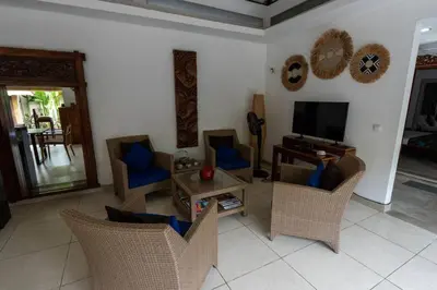 a living room with chairs and a flat screen tv at Kangin villa 2 bedrooms in the heart of Seminyak in Kuta