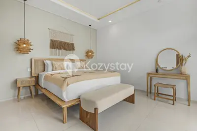 a bedroom with a large bed and a mirror at Salila Villa by Kozystay - Umalas in Kerobokan