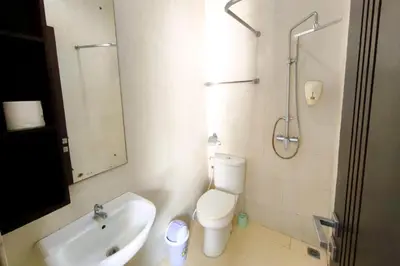 a bathroom with a toilet and a sink and a shower at Domaxo Villa in Seminyak