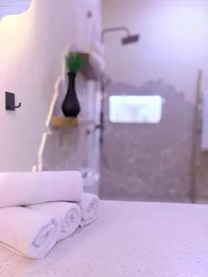 a pile of towels sitting on a bed in a bathroom at Villa Grand in Sanur