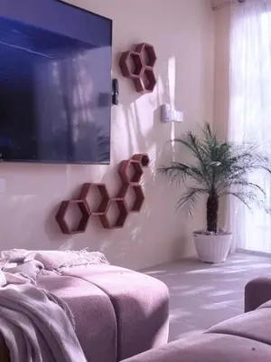 a bedroom with a tv and a potted plant at Villa Grand in Sanur