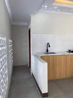 a kitchen with a sink and a counter top at Villa Damai in Sanur