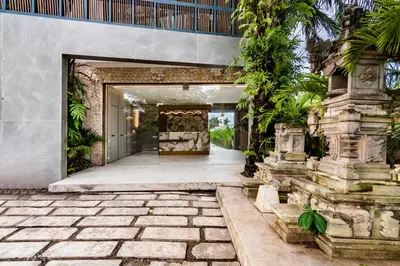 an open door to a house with a courtyard at Anoya Boutique Villa in Kerobokan