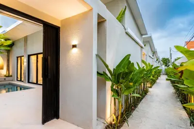 an open door to a house with plants at Anoya Boutique Villa in Kerobokan