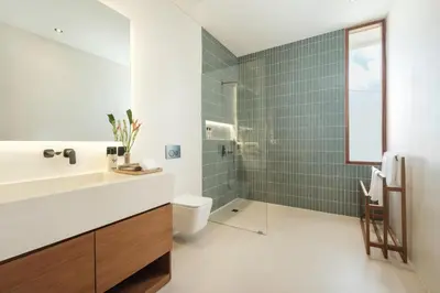 a bathroom with a sink and a toilet and a shower at Manu Villas in Sanur
