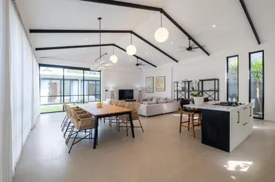 a kitchen and living room with a table and chairs at Villa Seminyak Beachside Luxury in Seminyak
