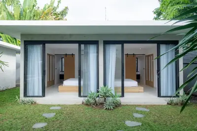 a bedroom in a house with two beds at Villa Seminyak Beachside Luxury in Seminyak