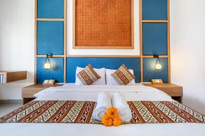 a bedroom with two beds with towels on them at Uma Katani in Jimbaran