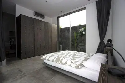 a bedroom with a large bed and a large window at Modern 4BD Villa with Pool in Seminyak