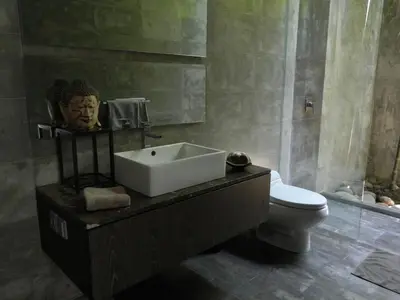 a bathroom with a sink and a toilet at Modern 4BD Villa with Pool in Seminyak