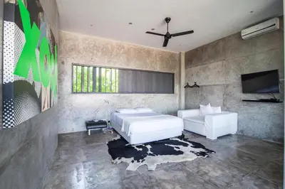 a bedroom with a white bed and a tv at Modern 4BD Villa with Pool in Seminyak