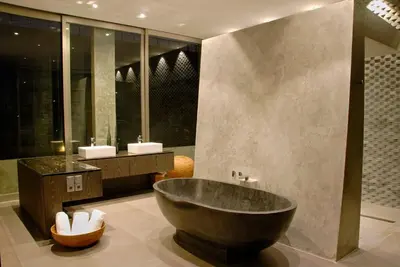 a bathroom with a large tub and two sinks at Modern 4BD Villa with Pool in Seminyak
