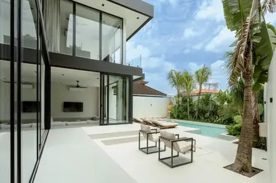 an external view of a house with a patio and a pool at Ultra-Luxe 4BR Seminyak Villa - Indoor AC Living & Private Pool in Seminyak