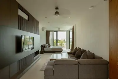 a living room with a couch and a tv at Ultra-Luxe 4BR Seminyak Villa - Indoor AC Living & Private Pool in Seminyak