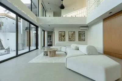 a living room with a white couch and a table at Ultra-Luxe 4BR Seminyak Villa - Indoor AC Living & Private Pool in Seminyak