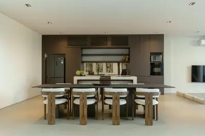a kitchen with a large dining table and chairs at Ultra-Luxe 4BR Seminyak Villa - Indoor AC Living & Private Pool in Seminyak