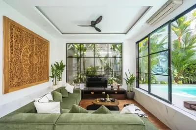 a living room with a green couch and a tv at Villa Samyati Kerobokan in Seminyak