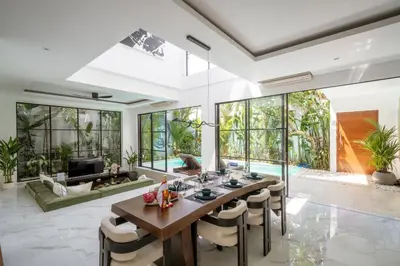 a dining room with a long table and chairs at Villa Samyati Kerobokan in Seminyak