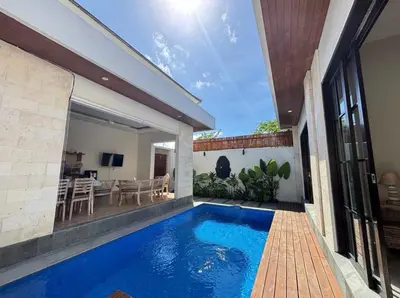 a swimming pool in the backyard of a house at FrangipaniVilla in Seminyak