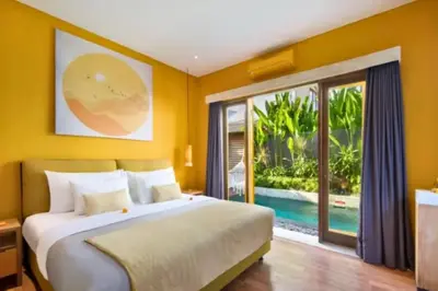 a bedroom with a large bed and a large window at Teagan Pretty 1 BR Royal Private Pool Villa With Waterslide in Kerobokan