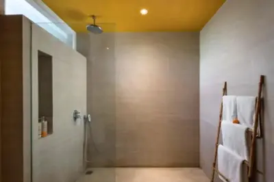 a bathroom with a shower with white towels on a wall at Teagan Pretty 1 BR Royal Private Pool Villa With Waterslide in Kerobokan