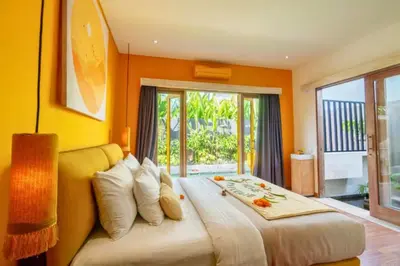 a bedroom with a large bed with orange walls at Tindra Stunning 2 BR Royal Private Pool Villa With Waterslide in Kerobokan
