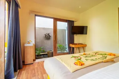 a bedroom with a bed and a window at Tindra Stunning 2 BR Royal Private Pool Villa With Waterslide in Kerobokan