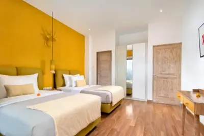 a hotel room with two beds and a desk at Tindra Stunning 2 BR Royal Private Pool Villa With Waterslide in Kerobokan