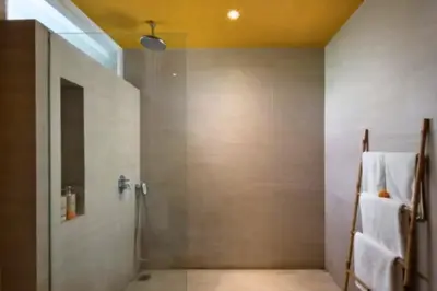 a bathroom with a shower with a glass door at Tindra Stunning 2 BR Royal Private Pool Villa With Waterslide in Kerobokan