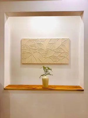 a plant on a wooden shelf on a wall at Casa Da Luca Beachside Sanur in Sanur