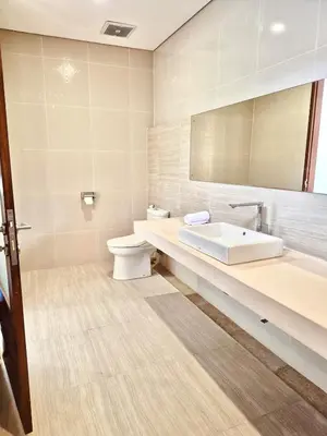 a bathroom with a sink and a toilet and a mirror at Casa Da Luca Beachside Sanur in Sanur