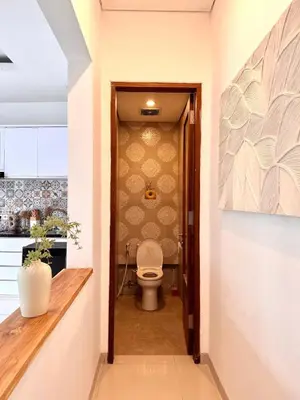 a hallway with a toilet in a kitchen at Casa Da Luca Beachside Sanur in Sanur