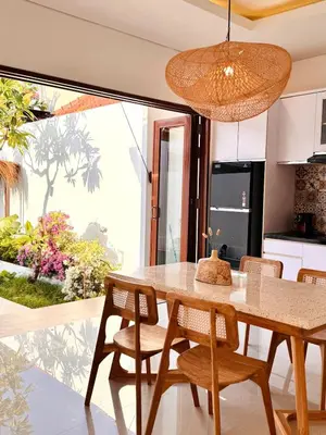 a kitchen and dining room with a table and chairs at Casa Da Luca Beachside Sanur in Sanur