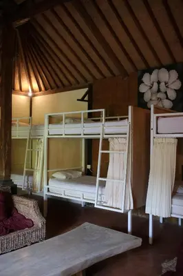 a room with two bunk beds in a house at The Secreet Garden Hotel in Denpasar