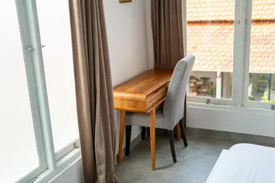 a wooden desk in a room with windows at Charming 3 BR villa in the heart of Umalas in Canggu