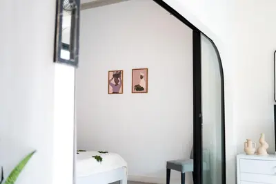 a hallway with a mirror and a chair at Charming 3 BR villa in the heart of Umalas in Canggu