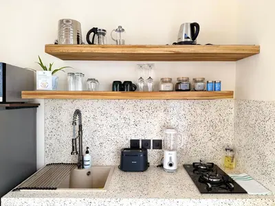 a kitchen with a counter top with a sink and a stove at House of Rakiki Legian - 2BR Private Pool Villa in Central Legian close to Beach in Legian