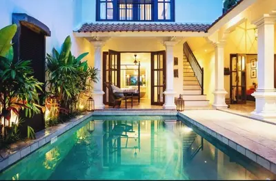 a house with a swimming pool in front of a house at Seminyak Pool Villa in Seminyak