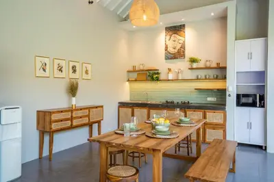 a kitchen with a wooden table and a dining room at Casa Oliva - Tropical Pool Villa on Trendy Seminyak Eat Street in Seminyak