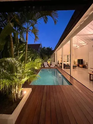 a swimming pool in a house with a wooden deck at Casa Oliva - Tropical Pool Villa on Trendy Seminyak Eat Street in Seminyak