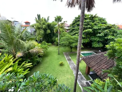 an aerial view of a garden with a pool at Palm 57 Guest House Legian in Legian