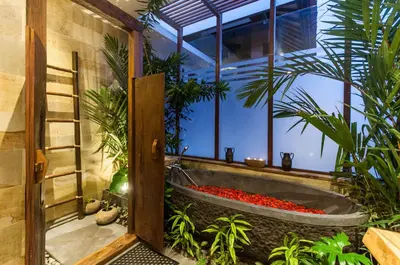 a large bath tub in a room with plants at A Luxurious Boutique Villa in Seminyak's Heart in Seminyak