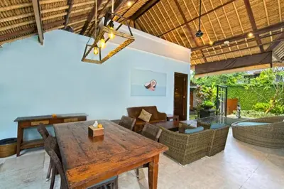 a living room with a wooden table and a couch at Malaya Stunning 1 BR Private Pool Villa With Bathtub in Seminyak