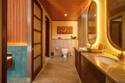 a bathroom with a sink and a toilet at Malaya Stunning 1 BR Private Pool Villa With Bathtub in Seminyak