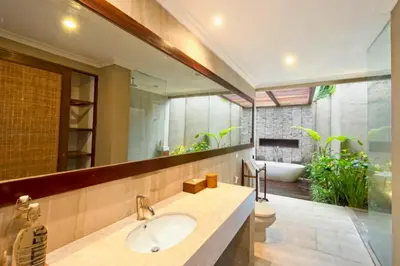 a bathroom with a sink and a large mirror at Malaya Stunning 1 BR Private Pool Villa With Bathtub in Seminyak