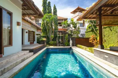 a swimming pool in the backyard of a house at Malayna Comfortable 2 BR Royal Private Pool Villa in Seminyak