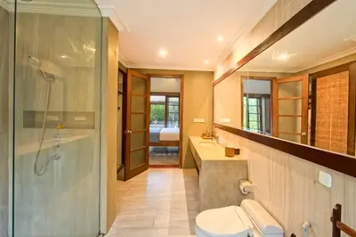 a bathroom with a shower and a toilet and a sink at Malayna Comfortable 2 BR Royal Private Pool Villa in Seminyak