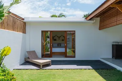 a patio with a chair and a house at Villa Sora by Alfred in Bali in Seminyak
