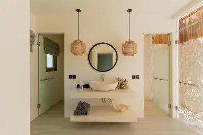 a bathroom with a sink and a mirror at Villa Sora by Alfred in Bali in Seminyak